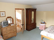 Double room featuring wardrobe and chest of drawers for ample storage